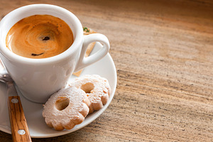Italian breakfast with espresso coffee and canestrelli biscuits on wooden table, a Food & Drink Photo by Antonio Gravante Market