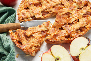 Homemade apple pie with ingredients on concrete background, a Food & Drink Photo by Olena Rudo