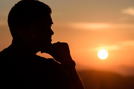 Man with hands on chin stand on the mountain and watching over t, a Person Photo by Byrdyak