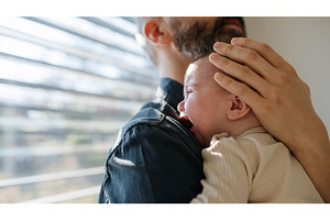 Father comforting his crying baby, a Person Photo by HalfPoint