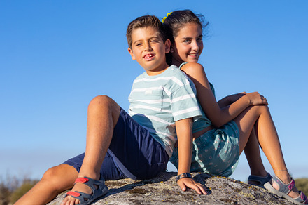 Two kids  with on a top of a rock on their summer vacation, a Person Photo by Cosca