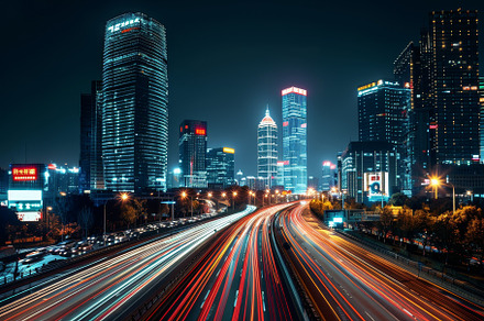 A bustling city skyline illuminated, a Photo by Tanuart