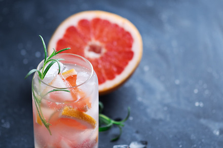 Stylish summer ice alcoholic cocktail with grapefruit and rosemary. Gin and ton, a Food & Drink Photo by PavelKant