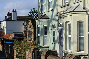 Traditional English terrace houses lining a sunny residential st, a Photo by Studio ANNA