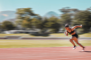 Speed, track and fast woman running for fitness health, exercise and workout for marathon race, contest or competition. Sports commitment, sprint action or athlete runner training for France olympics, a Photo by Peopleimages.com