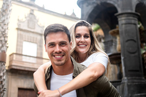 Happy romantic couple smiling together during city vacation, a Person Photo by etorres69