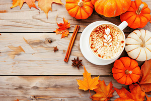 Close-up of a pumpkin spice latte with latte art, surrounded by pumpkins, autum, a Holiday Photo by Mashimara