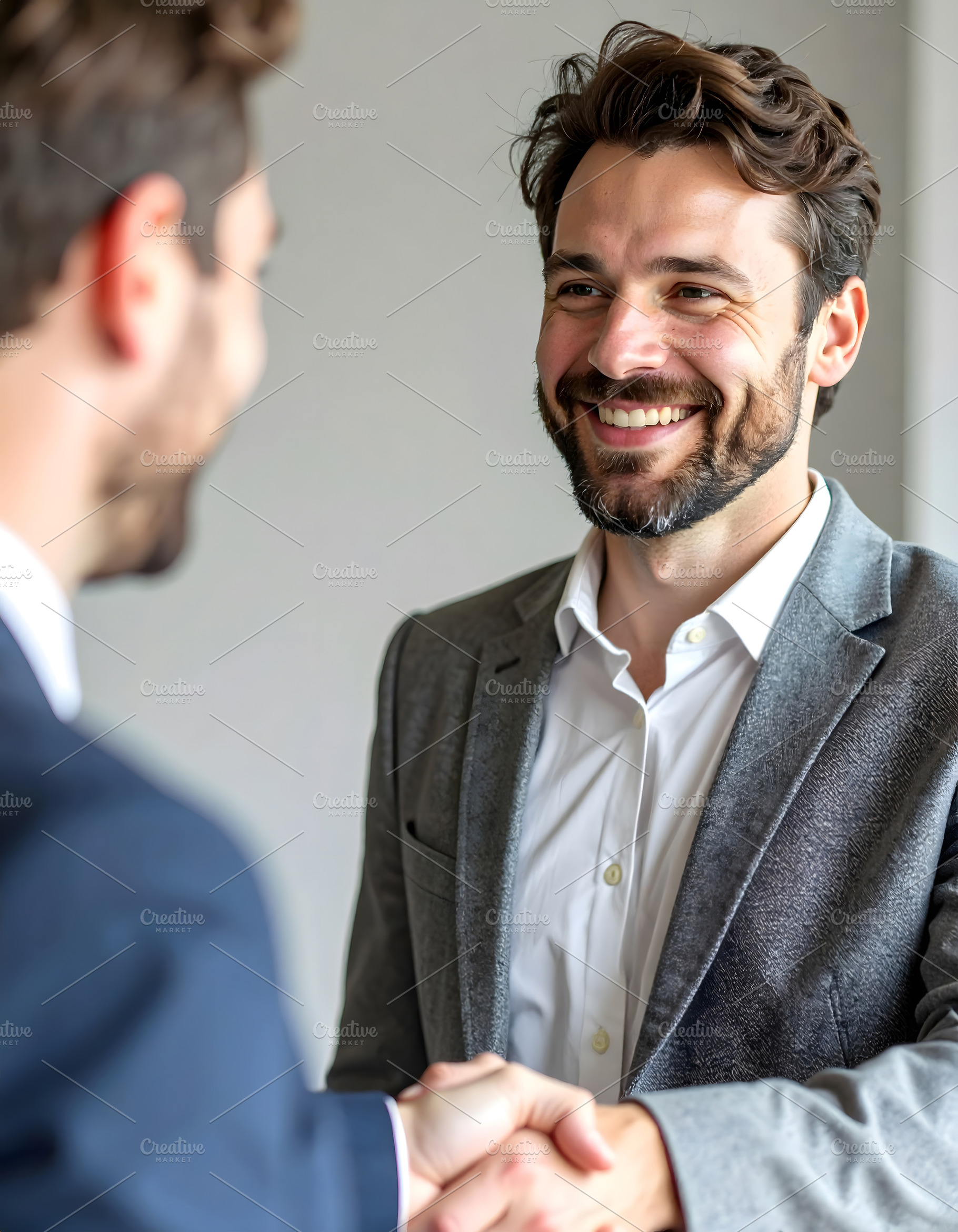 Businessman smiling while shaking hands in professional agreemen, a Business Photo by GoodGoods