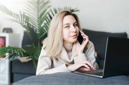 Young woman working on laptop in  home, a Person Photo by Olena Rudo