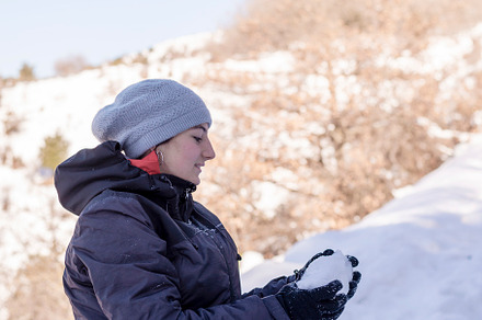Young woman in the snow mountains landscape on holiday holding natural soft whi, a Background Photo by RF Images