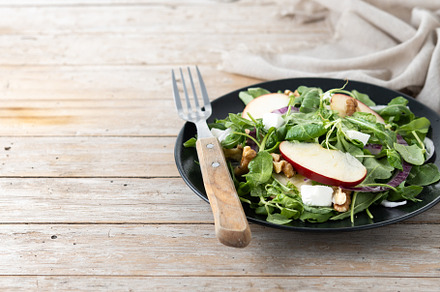Autumn salad with apples and walnuts on wooden table, a Food & Drink Photo by etorres69