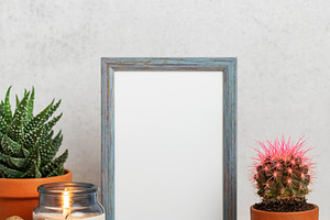 Empty frame, burning candle and succulents creating cozy home at, a Nature Photo by Olena Rudo