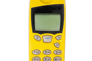 Old yellow mobile phone isolated, a Technology Photo by BOOCYS
