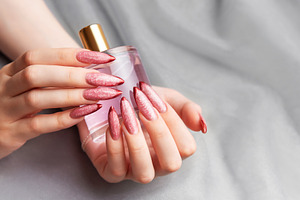 Woman's hands holding elegant perfume bottle with red manicure, a Beauty & Fashion Photo by Olena Rudo
