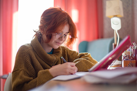 schoolgirl with glasses doing homework., a Photo by Pictures for you!!!!!!!!!