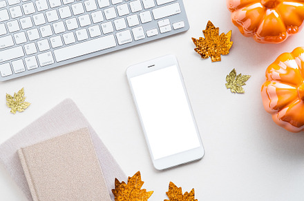 Autumn desk table with smartphone, a Technology Photo by photoguns