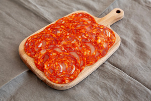 Cold Meat Chorizo Slices on a Wooden Board, side view., a Food & Drink Photo by LiudmylaChuhunova