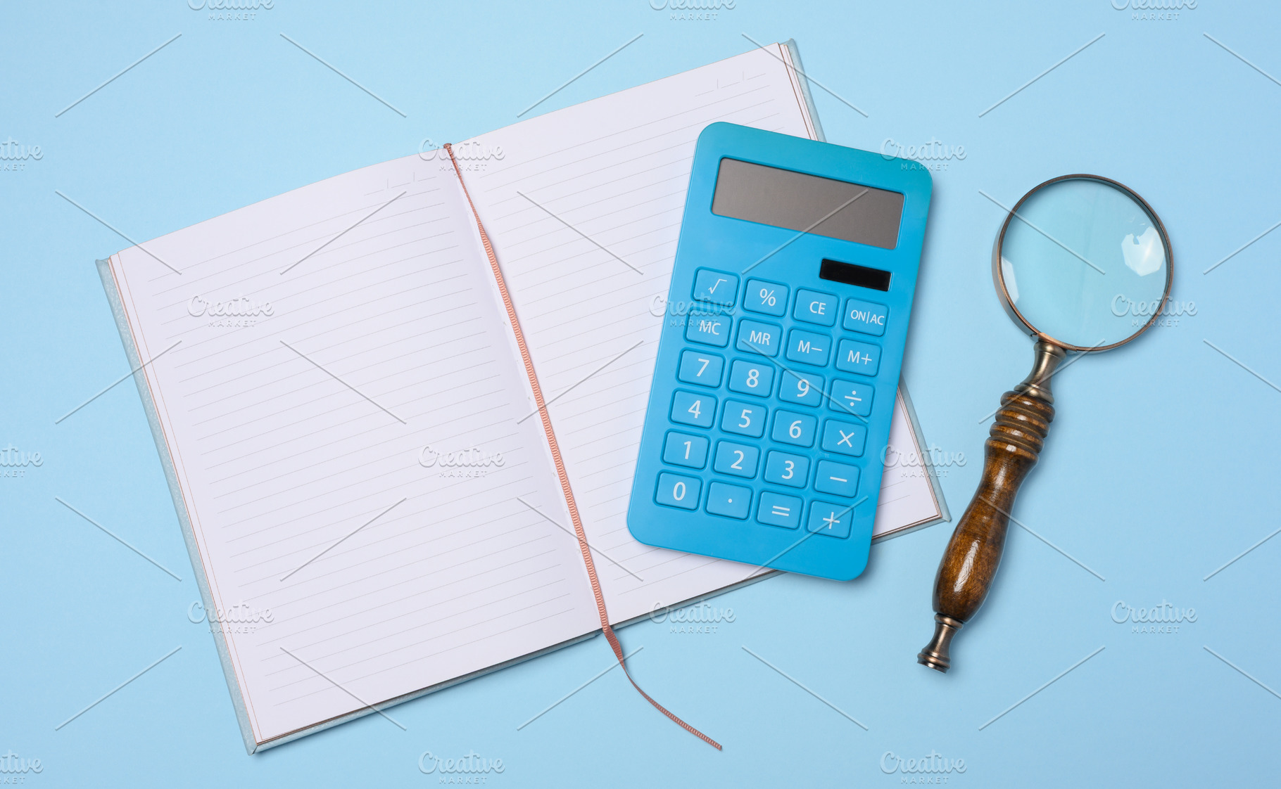 An open notebook, a blue calculator, and a vintage magnifying gl, a Business Photo by ndanko