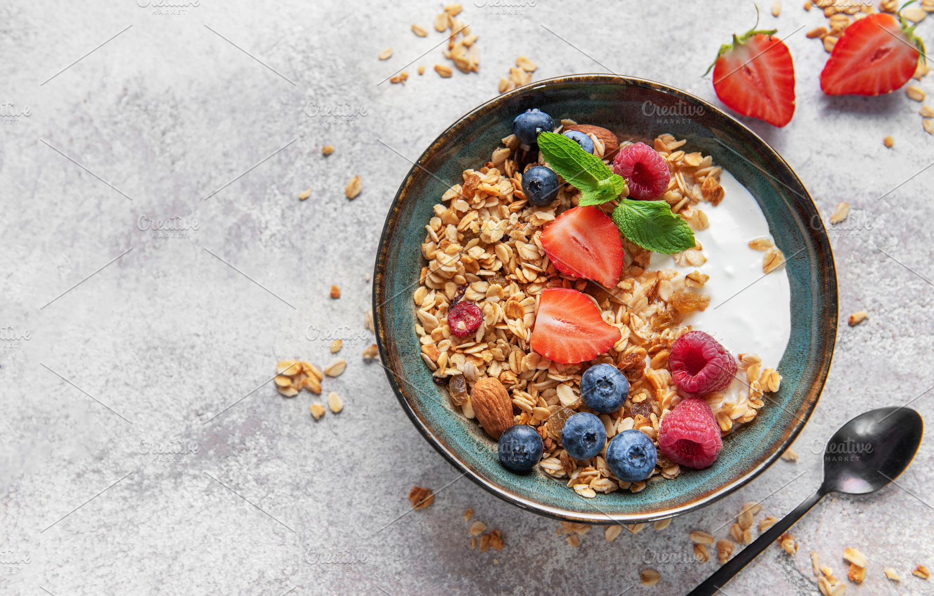 Granola bowl with yogurt, berries, and nuts for breakfast, a Food & Drink Photo by Olena Rudo