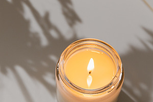 White burning candle on coffee table, an Arts & Entertainment Photo by Edalin's Store