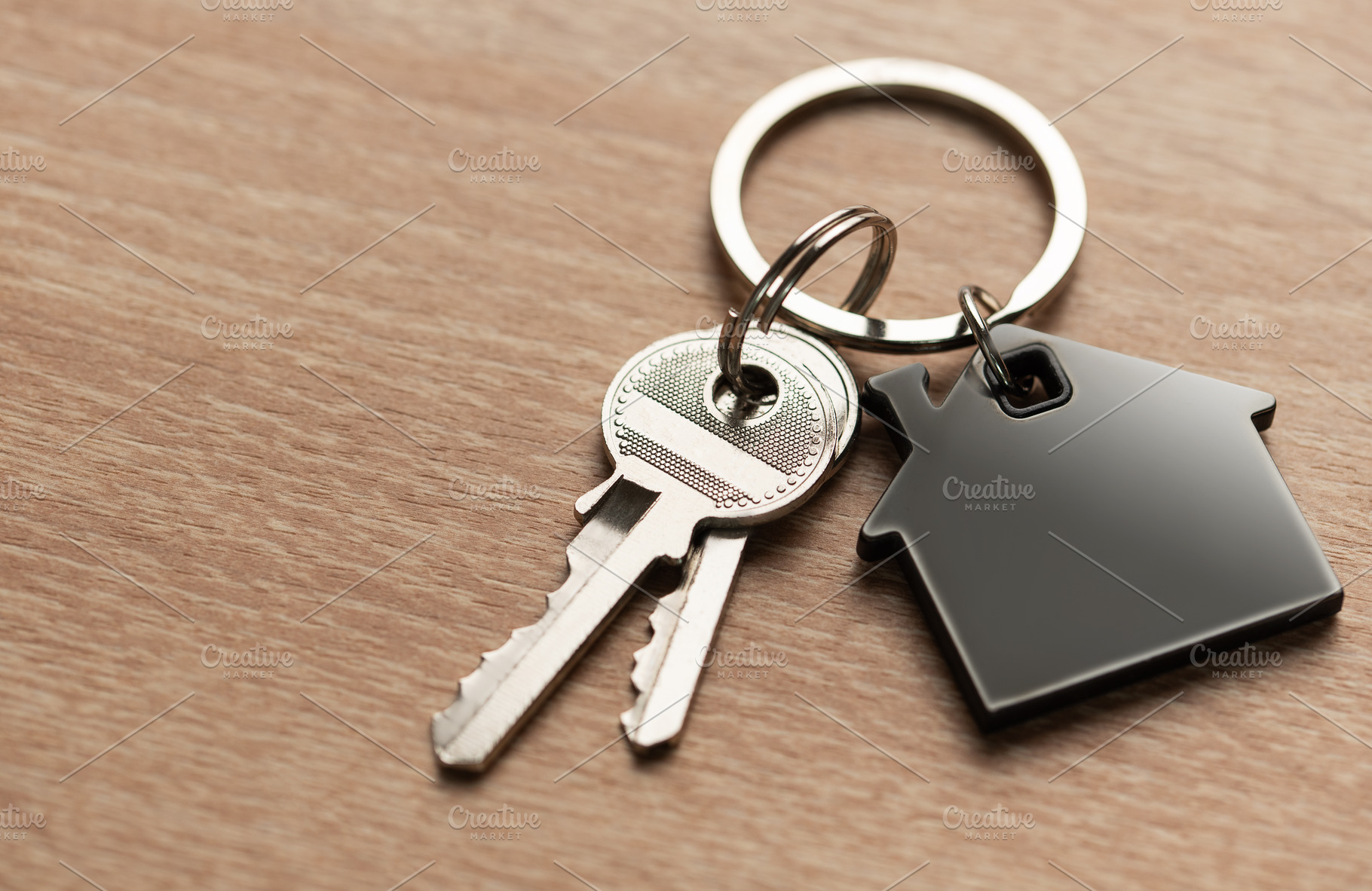 House keys with house shaped keychain on wood, a Business Photo by Olena Rudo