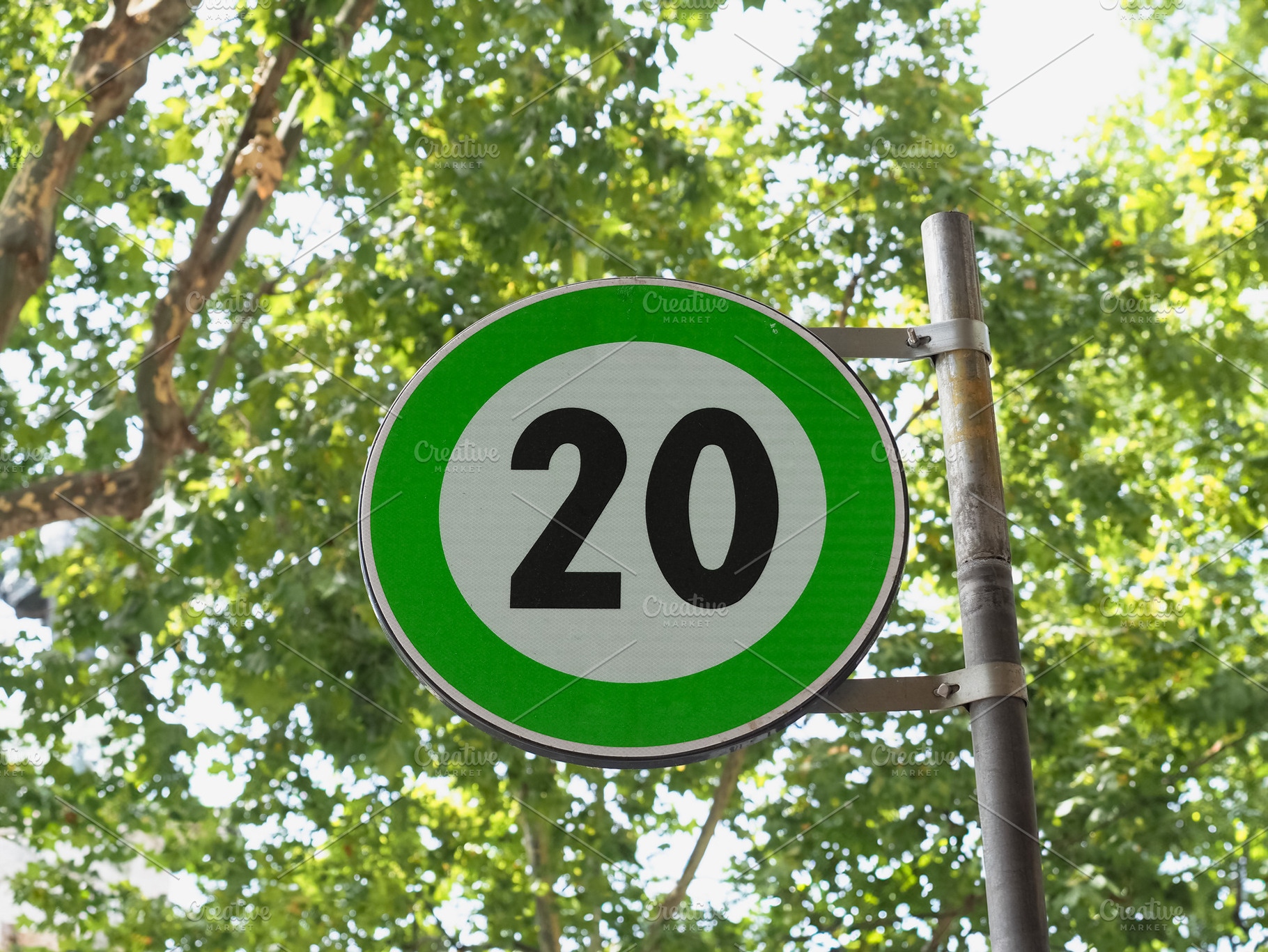 Green advisory speed limit sign, a Photo by WorldOfPhotos