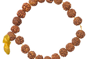 A Rudraksha bracelet made of brown beads with a yellow tassel, f, an Abstract Photo by ndanko
