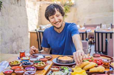 Man eating turkish breakfast, a Food & Drink Photo by Elizaveta Galitskaya
