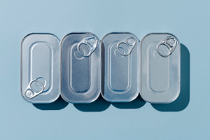four unopened tin cans of canned food, a Photo by Nito