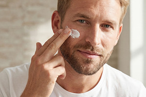 Man Applying Skincare Cream to Face, a Beauty & Fashion Photo by Virgo Studio