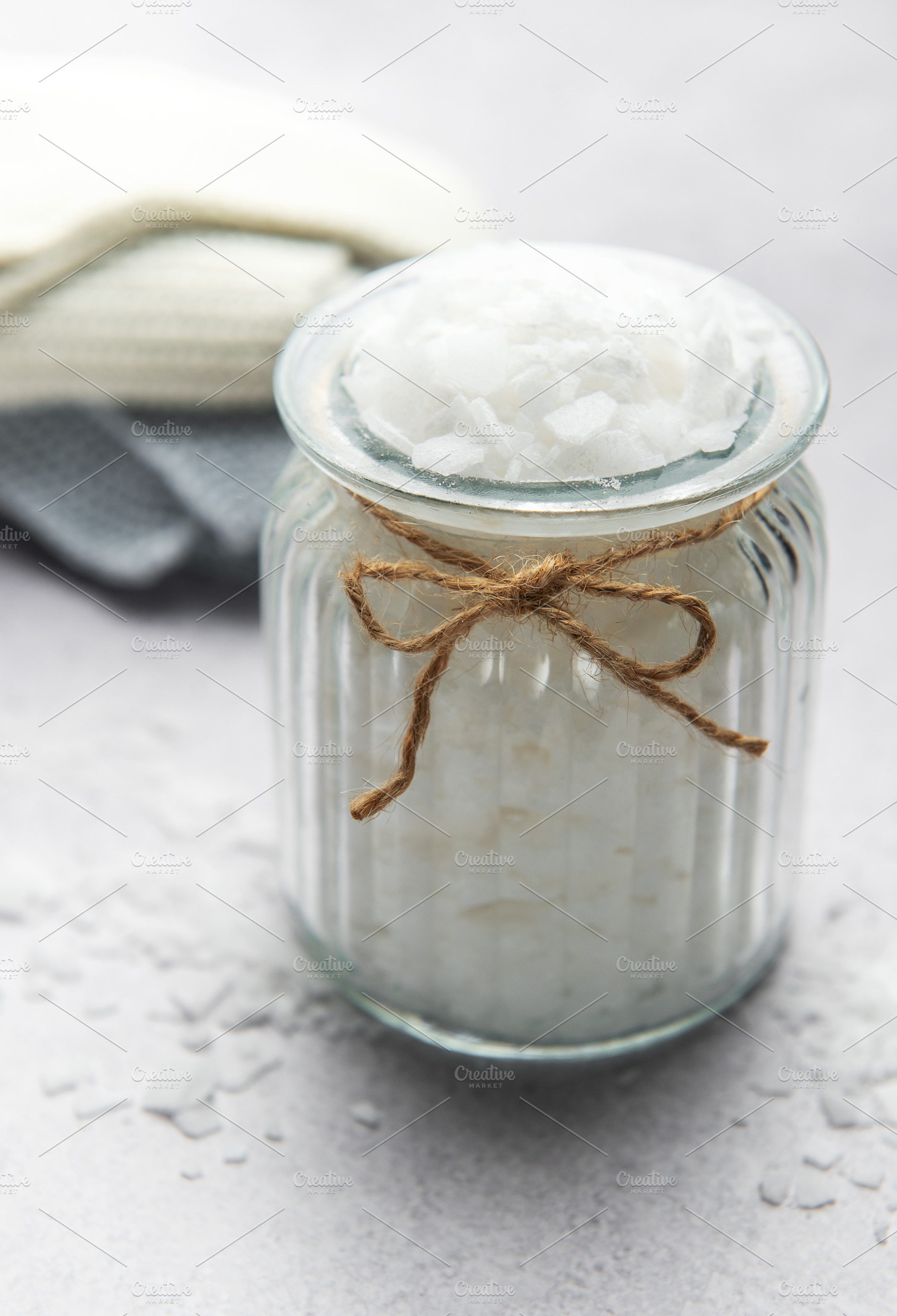 Magnesium flakes in glass jar for a relaxing bath with towels, a Beauty & Fashion Photo by Olena Rudo