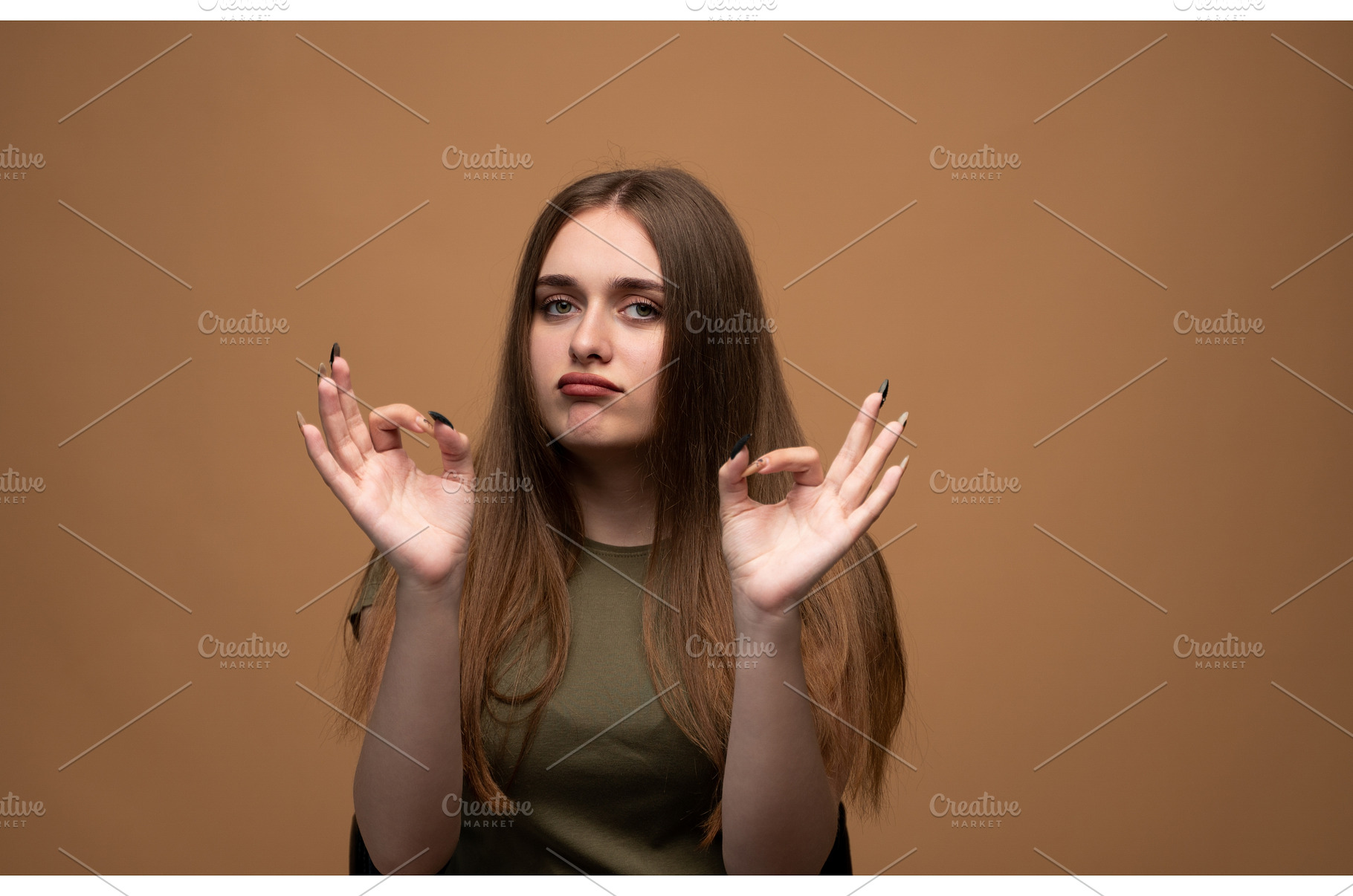 Young woman making okay gesture with, a Person Photo by volodymyrshtun13795