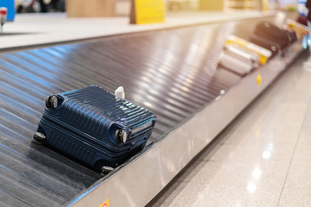Suitcase or luggage with conveyor belt in the airport, a Transportation Photo by Casanowe-studio