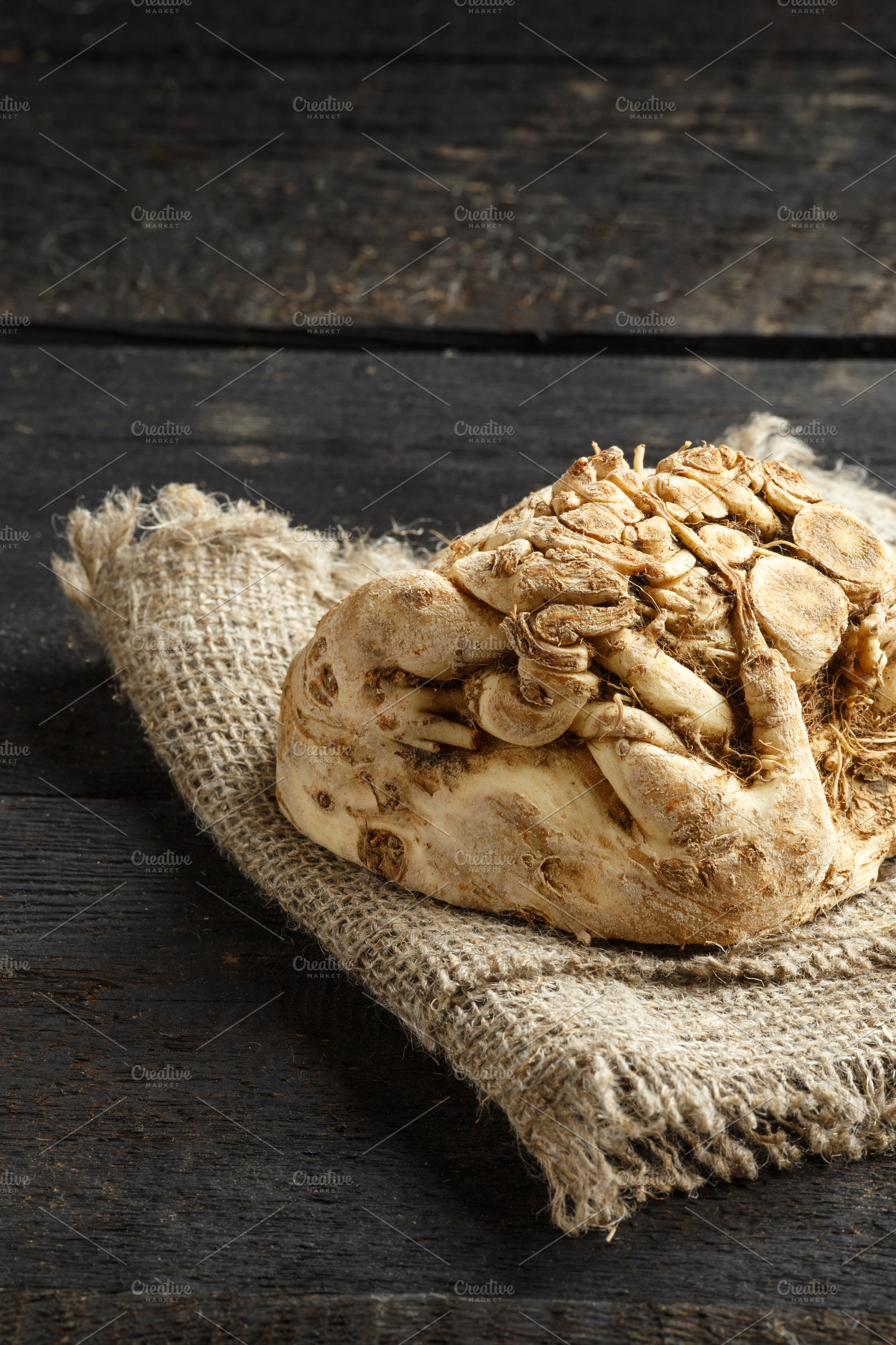 celery root and burlap on dark wooden background, a Food & Drink Photo by tatyanatitova
