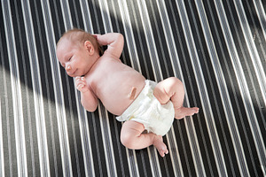 Cute newborn baby in a white diaper