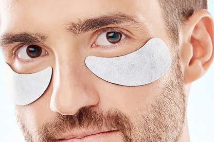 Eye beauty, man portrait and treatment patches for eyes in a isolated studio with white background. Skincare, spa wellness and facial for model face with cosmetics, dermatology and detox with mask, a Photo by Peopleimages.com