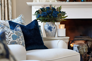 Cozy living room interior with burning fireplace, decorative blue roses, festiv, a Holiday Photo by Studio ANNA