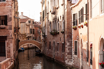 Typical bridge made with red bricks on the typical canal in Venice, an Architecture Photo by Bepslabor