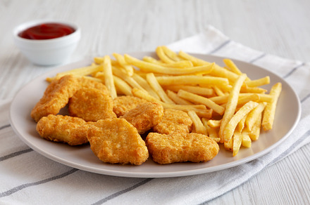 Fried Chicken Nuggets with French Fries on a Plate, side view., a Food & Drink Photo by LiudmylaChuhunova