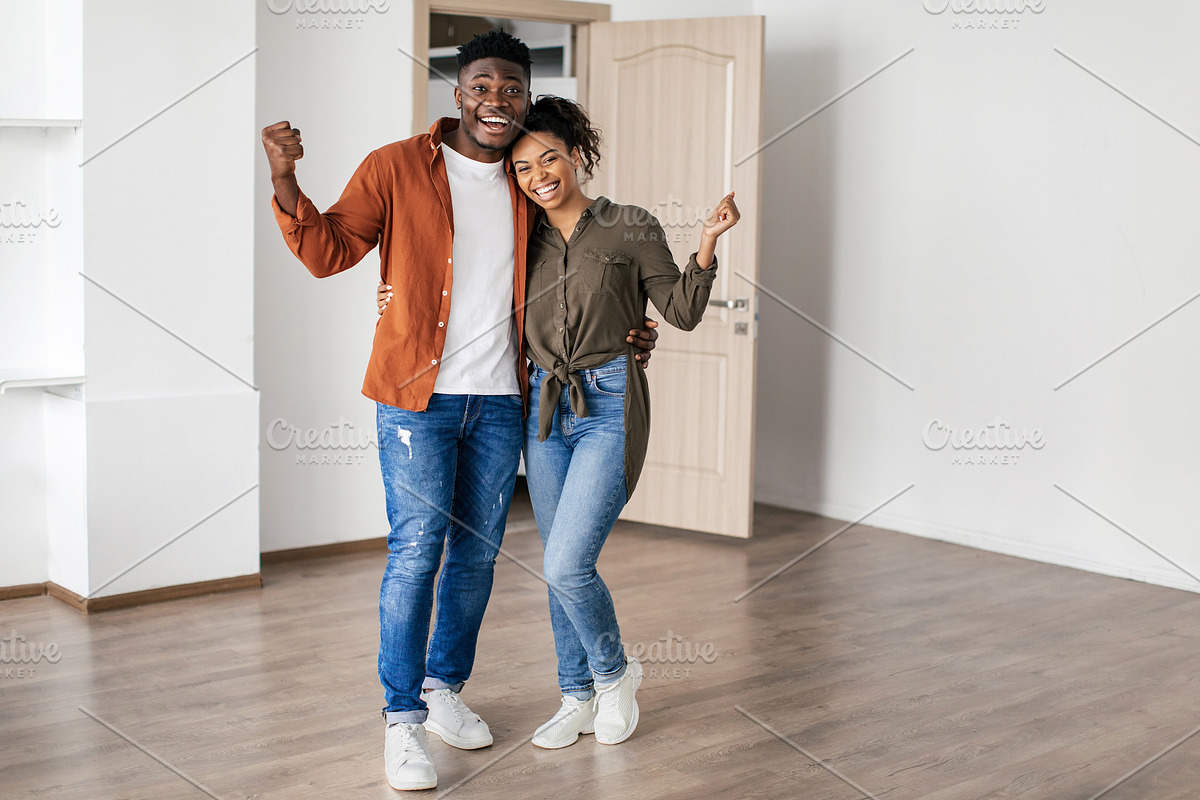 Joyful Black Couple Gesturing Yes Celebrating Moving To New Home, a Photo by Prostock-Studio (Photo 1 of 2)
