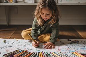 Child drawing with crayons on paper, a Person Photo by Virgo Studio