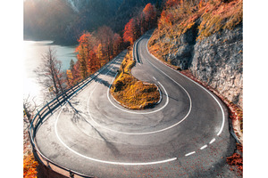 Aerial view of winding mountain road, a Nature Photo by den-belitsky
