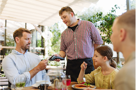 Man paying for lunch in a restaurant, a Business Photo by HalfPoint