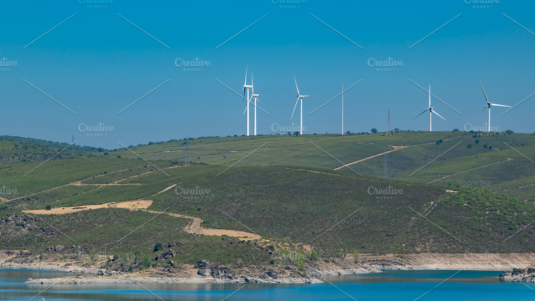 Lake surrounded by hills and arid landscape, a Transportation Photo by DanFLCreativo