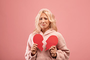 Unhappy lady holding two halves of cut paper heart and crying, feeling hurt, go, a Photo by Prostock-Studio (Thumbnail 2 of 2)