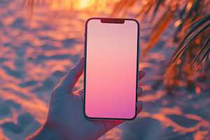 A hand holding a smartphone iPhone mockup against a vibrant sunset background o, an iPhone Mockup by Textures & Backgrounds