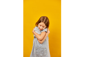 Young girl in striped shirt embraces, a Beauty & Fashion Photo by IlliaBondarPhotography