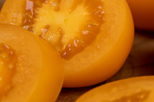 orange tomatoes cut into pieces, clean washed tomatoes are sliced for salad pre, a Photo by rsoollAI