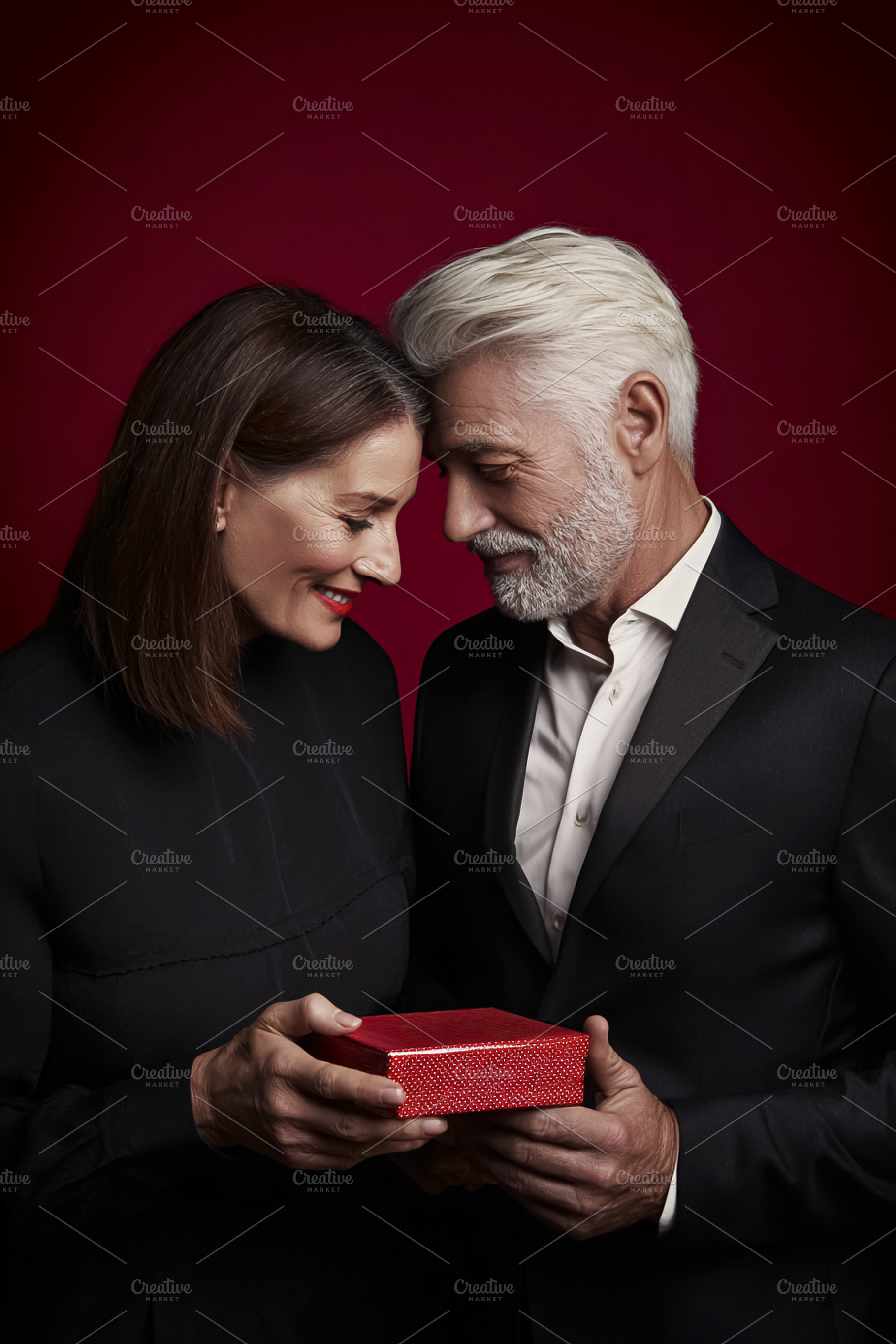 Senior couple sharing a red gift box, expressing love and romanc, a Photo by Studio ANNA