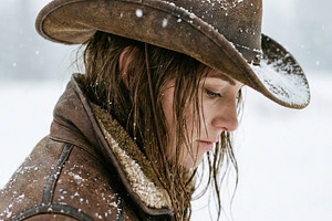 Pensive Woman in Snowy Cowboy Hat, a Person Photo by Virgo Studio
